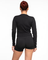 The Micro Rib Crop Long Sleeve - Black - Training Club - Center Chest Stacked - Printed - White