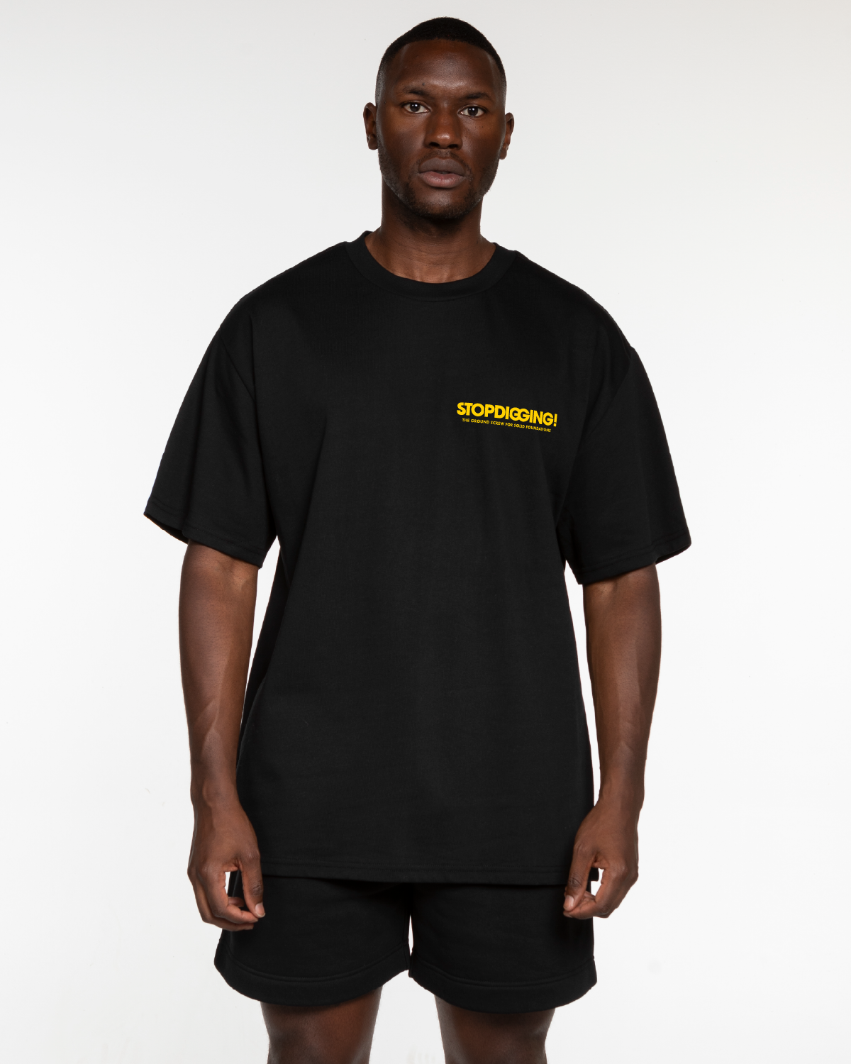 The Mens Heavyweight Tee - Black - Groundbreakers - Left Chest Stacked - Yellow