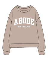 The Midweight Unisex Crewneck - Washed Cement - Abode Skin & Wellness - Center Chest Stacked - Printed White