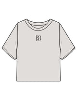 The Heavyweight Crop Tee - Washed Bone - Komo Studio - Center Chest Stacked - Printed - Black