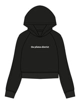 The Womens Crop Hoodie - Black - THE PILATES DISTRICT - Center Chest - Printed - White