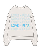 The Womens Crewneck - Bone - Love > Fear - Center Chest & Back Stacked - Tiffany Blue (66C6E8)
