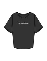 The Crop Tee - Washed Black - THE PILATES DISTRICT - Center Chest - Printed - White