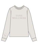 The Womens Heavyweight Long Sleeve - Washed Bone - Tone Wellness Studio - Center Chest Stacked - Right Wrist - Printed - Tone on Tone