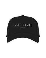 The Canvas Cap - Black - Salt + Light Hair Co - Center Chest Stacked -  ‘SALT + LIGHT’ - White Puff Embroidered -  'Hair Co.’ - White Flat Embroidered